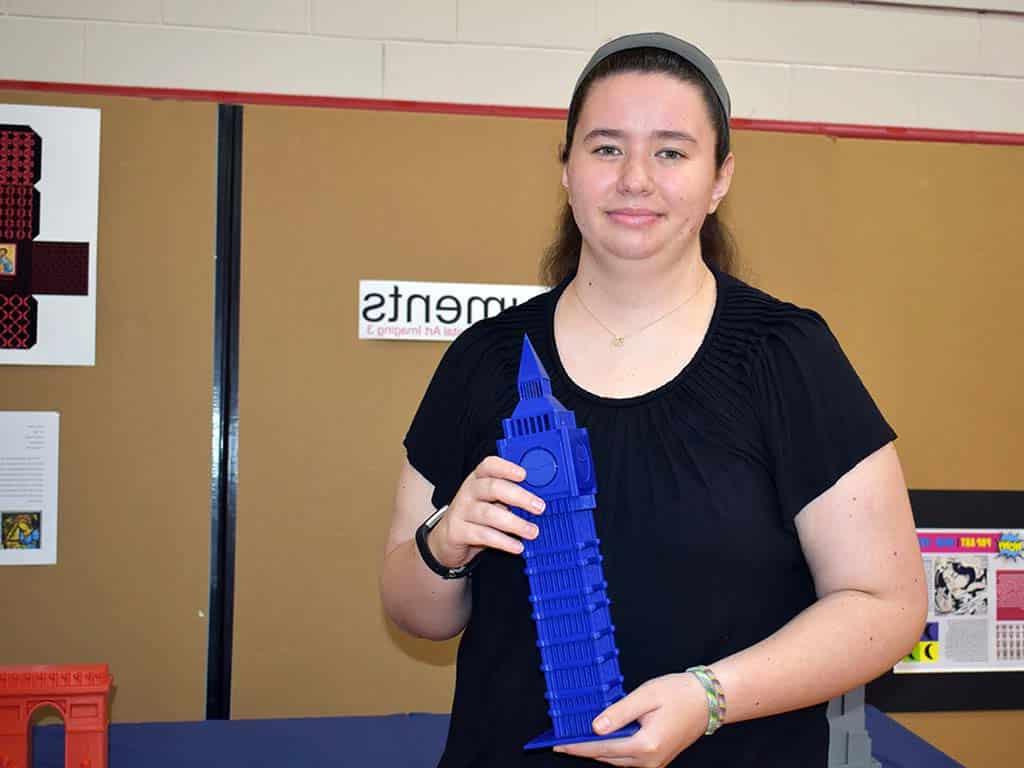 Female art student holding sculpture