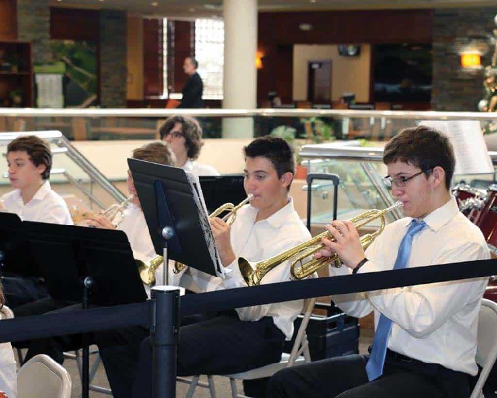 Male students playing trumpet